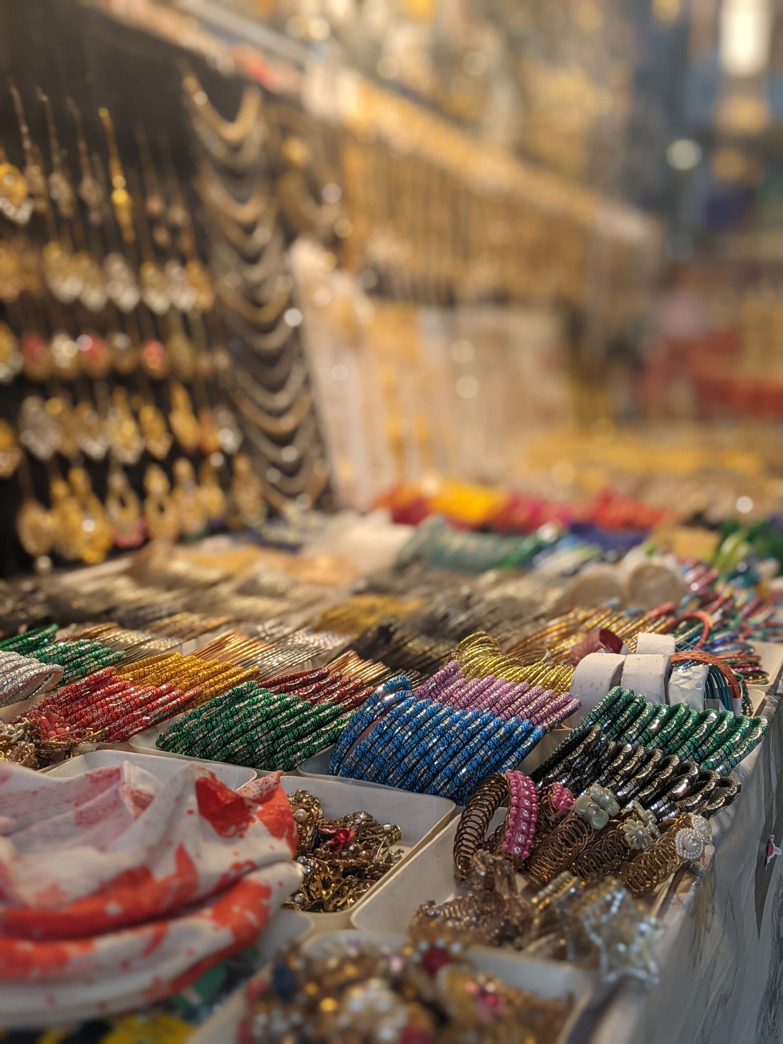 Vibrant collection of jewelry bracelets on display in a bustling Dhaka market.